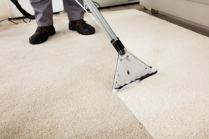 Professional carpet cleaning machine in use on a Cambridge living room carpet